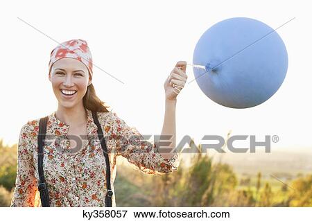 Beautiful woman playing with a balloon and smiling View Large Photo Image Stock Photo - Beautiful woman playing with a balloon and smiling. Fotosearch