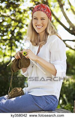 Cheerful young woman knitting View Large Photo Image Stock Image - Cheerful young woman knitting. Fotosearch
