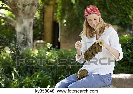 Cheerful young woman knitting View Large Photo Image Stock Photo - Cheerful young woman knitting. Fotosearch