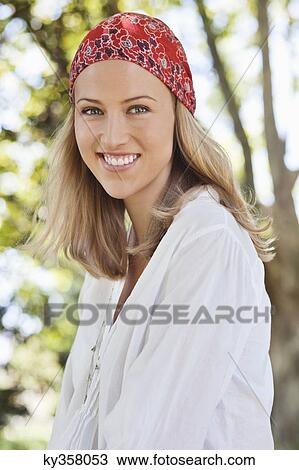 Cheerful young woman wearing bandana View Large Photo Image Stock Image - Cheerful young woman wearing bandana. Fotosearch