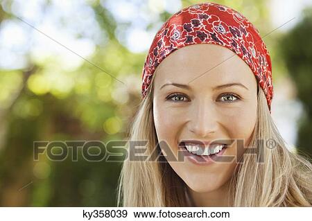 Stock Photo - Cheerful young woman wearing bandana. Fotosearch