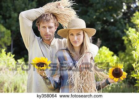 Portrait of a couple in scarecrow pose in a field View Large Photo Image Picture - Portrait of a couple in scarecrow pose in a field. Fotosearch
