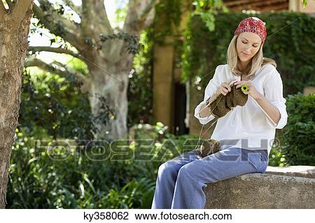 Smiling young woman knitting View Large Photo Image Stock Image - Smiling young woman knitting. Fotosearch