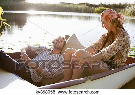 Young couple enjoying in the boat View Large Photo Image Stock Photo - Young couple enjoying in the boat. Fotosearch