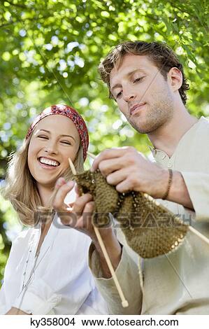 Young couple knitting together and smiling View Large Photo Image Picture - Young couple knitting together and smiling. Fotosearch