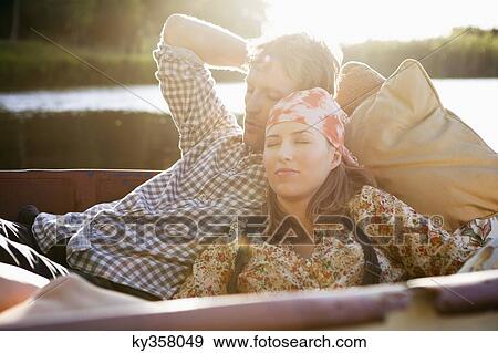 Young couple sleeping in the boat View Large Photo Image Stock Photo - Young couple sleeping in the boat. Fotosearch