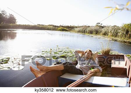 Young man sleeping in the boat View Large Photo Image Stock Image - Young man sleeping in the boat. Fotosearch