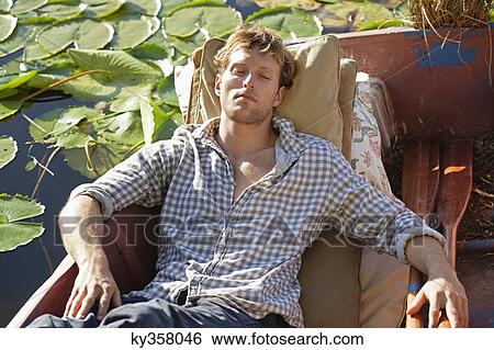 Young man sleeping in the boat View Large Photo Image Stock Photograph - Young man sleeping in the boat. Fotosearch