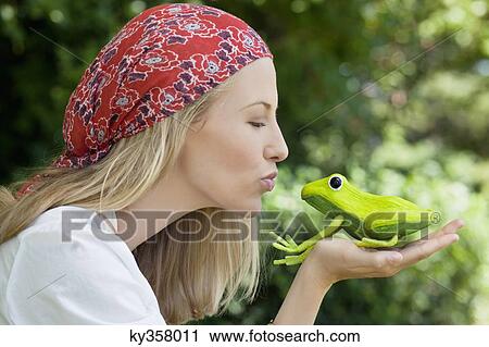 Young woman kissing a frog toy View Large Photo Image Stock Image - Young woman kissing a frog toy. Fotosearch