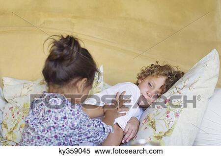 Cute siblings playing together at home View Large Photo Image Stock Photography - Cute siblings playing together at home. Fotosearch