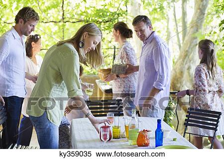 Family cleaning table after having food at house View Large Photo Image Stock Photography - Family cleaning table after having food at house. Fotosearch