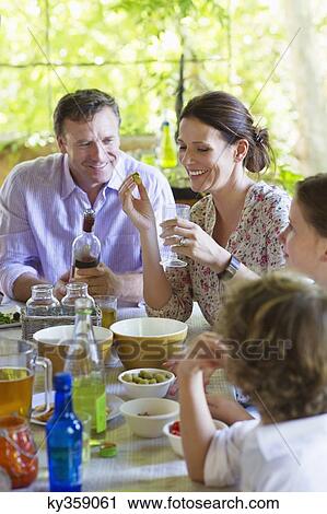 Family having food at home with their two children View Large Photo Image Stock Image - Family having food at home with their two children . Fotosearch