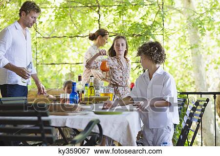 Family preparing for food at house View Large Photo Image Stock Photo - Family preparing for food at house. Fotosearch
