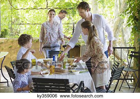 Stock Photograph - Family preparing for food at house. Fotosearch