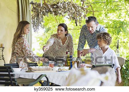 Family preparing for food at house View Large Photo Image Stock Photography - Family preparing for food at house. Fotosearch