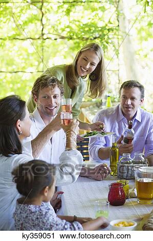Happy family having drink at house View Large Photo Image Stock Image - Happy family having drink at house. Fotosearch