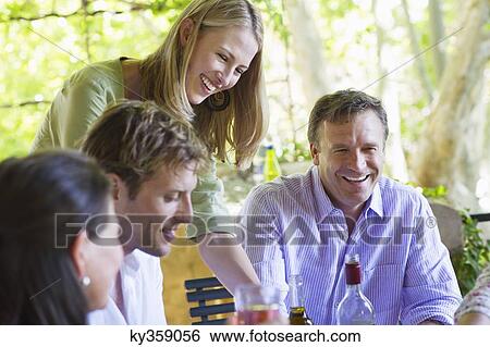 Happy family having drink at house View Large Photo Image Stock Photograph - Happy family having drink at house. Fotosearch
