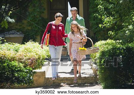 Happy family walking out of their house View Large Photo Image Stock Image - Happy family walking out of their house. Fotosearch