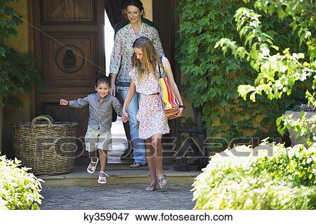 Happy family walking out of their house View Large Photo Image Stock Photo - Happy family walking out of their house. Fotosearch