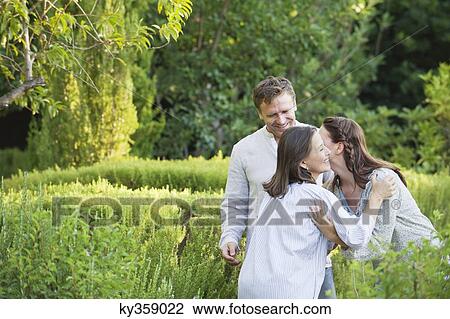 Mature couple hugging their mother in a garden View Large Photo Image Stock Image - Mature couple hugging their mother in a garden. Fotosearch