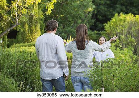 Mature couple walking towards their mother in a garden View Large Photo Image Stock Photography - Mature couple walking towards their mother in a garden. Fotosearch