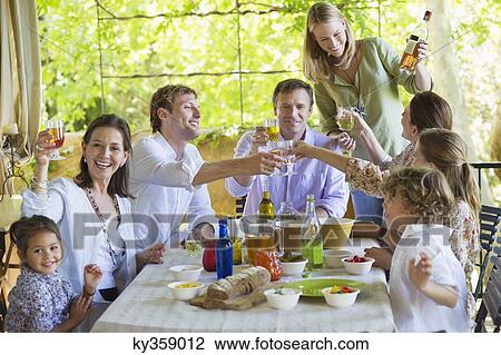 Multi generation family eating food at house View Large Photo Image Stock Image - Multi generation family eating food at house. Fotosearch