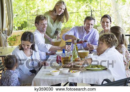 Multi generation family eating food at house View Large Photo Image Stock Image - Multi generation family eating food at house. Fotosearch