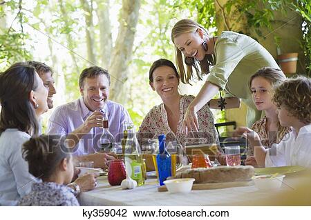 Multi generation family eating food at house View Large Photo Image Stock Image - Multi generation family eating food at house. Fotosearch