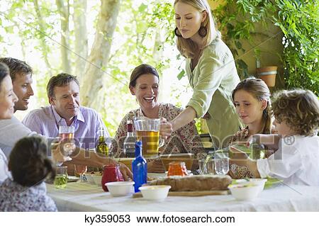 Multi generation family eating food at house View Large Photo Image Stock Image - Multi generation family eating food at house. Fotosearch