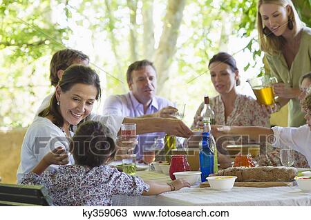 Multi generation family eating food at house View Large Photo Image Stock Image - Multi generation family eating food at house. Fotosearch