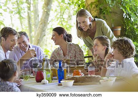 Multi generation family eating food at house View Large Photo Image Stock Photo - Multi generation family eating food at house. Fotosearch