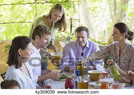 Multi generation family eating food at house View Large Photo Image Stock Photo - Multi generation family eating food at house. Fotosearch
