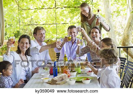 Stock Photo - Multi generation family eating food at house. Fotosearch