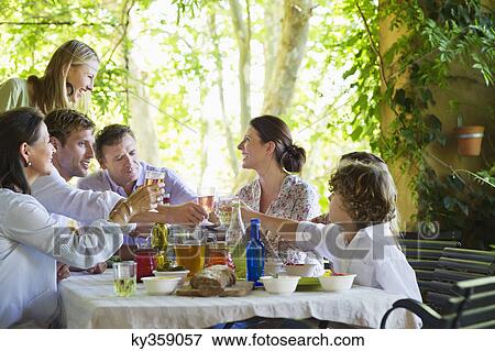 Multi generation family eating food at house View Large Photo Image Stock Photo - Multi generation family eating food at house. Fotosearch