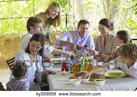 Multi generation family eating food at house View Large Photo Image Stock Photo - Multi generation family eating food at house. Fotosearch