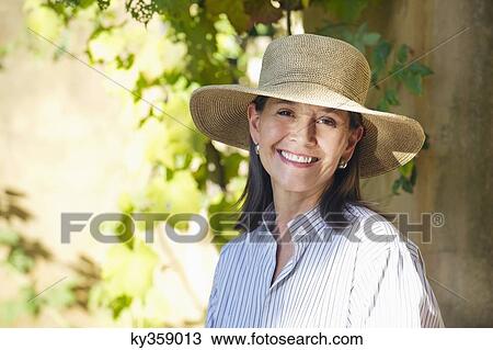 Portrait of a senior woman wearing hat and smiling View Large Photo Image Stock Image - Portrait of a senior woman wearing hat and smiling. Fotosearch
