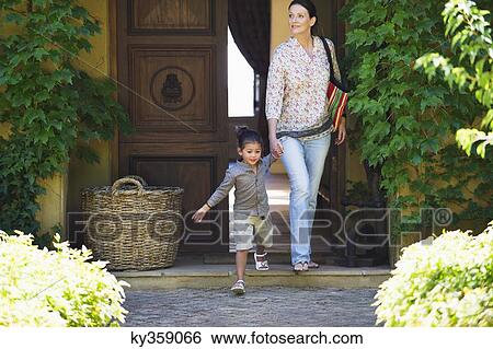 Woman and little girl walking out of their house holding hands View Large Photo Image Stock Photograph - Woman and little girl walking out of their house holding hands. Fotosearch