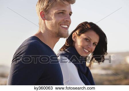 Close-up of a couple smiling View Large Photo Image Stock Image - Close-up of a couple smiling. Fotosearch