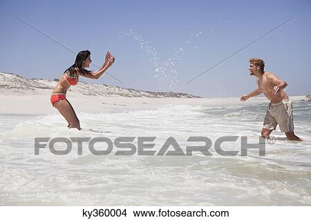 Couple enjoying on the beach View Large Photo Image Picture - Couple enjoying on the beach. Fotosearch