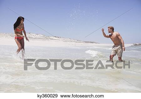 Couple enjoying on the beach View Large Photo Image Stock Photo - Couple enjoying on the beach. Fotosearch