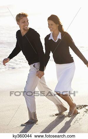 Couple running on the beach View Large Photo Image Picture - Couple running on the beach. Fotosearch