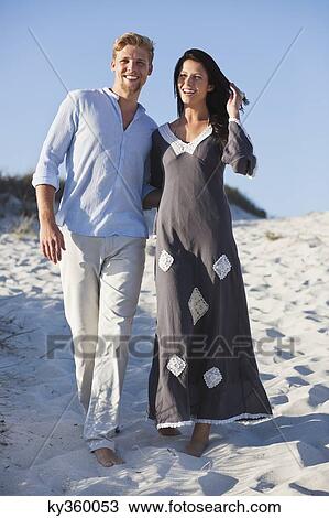 Couple walking on the beach View Large Photo Image Stock Image - Couple walking on the beach. Fotosearch