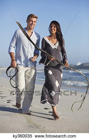 Couple walking on the beach View Large Photo Image Stock Photography - Couple walking on the beach. Fotosearch