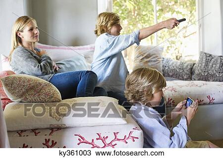 Children and mother using electronic gadgets at house View Large Photo Image Stock Image - Children and mother using electronic gadgets at house. Fotosearch