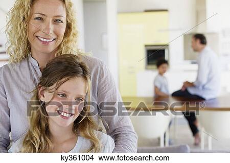 Close-up of a woman and her daughter smiling together View Large Photo Image Picture - Close-up of a woman and her daughter smiling together. Fotosearch