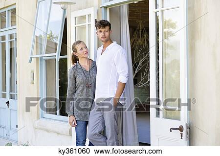 Stock Image - Couple standing together outdoors. Fotosearch