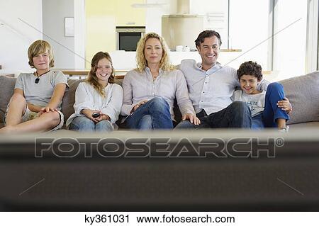 Family watching TV together at home View Large Photo Image Stock Image - Family watching TV together at home. Fotosearch