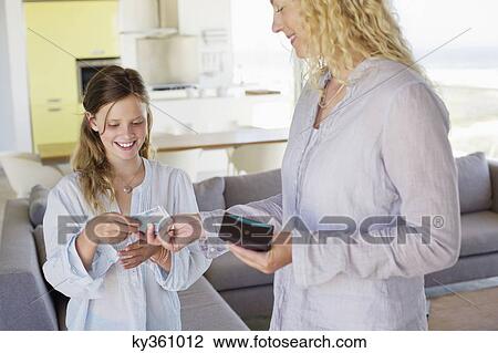 Stock Image - Girl taking money from her mother. Fotosearch