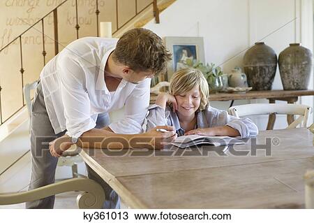 Man teaching his son at house View Large Photo Image Stock Image - Man teaching his son at house. Fotosearch