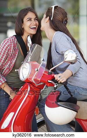 Close-up of two female friends enjoying together View Large Photo Image Stock Photograph - Close-up of two female friends enjoying together. Fotosearch